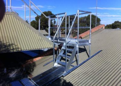 A galvanised access platform with stairs and ramp fabricated and installed on top of a commercial building by Cage Enterprises