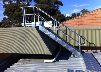 A galvanised access platform with stairs and ramp fabricated and installed on top of a commercial building by Cage Enterprises